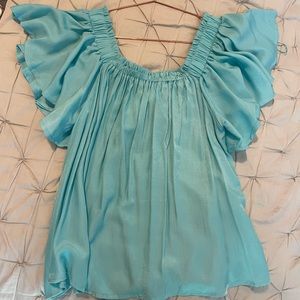 Cute turquoise blouse from a boutique called blue spero.